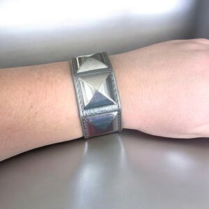 Michael Kors silver pyramid stud metallic leather cuff bracelet.